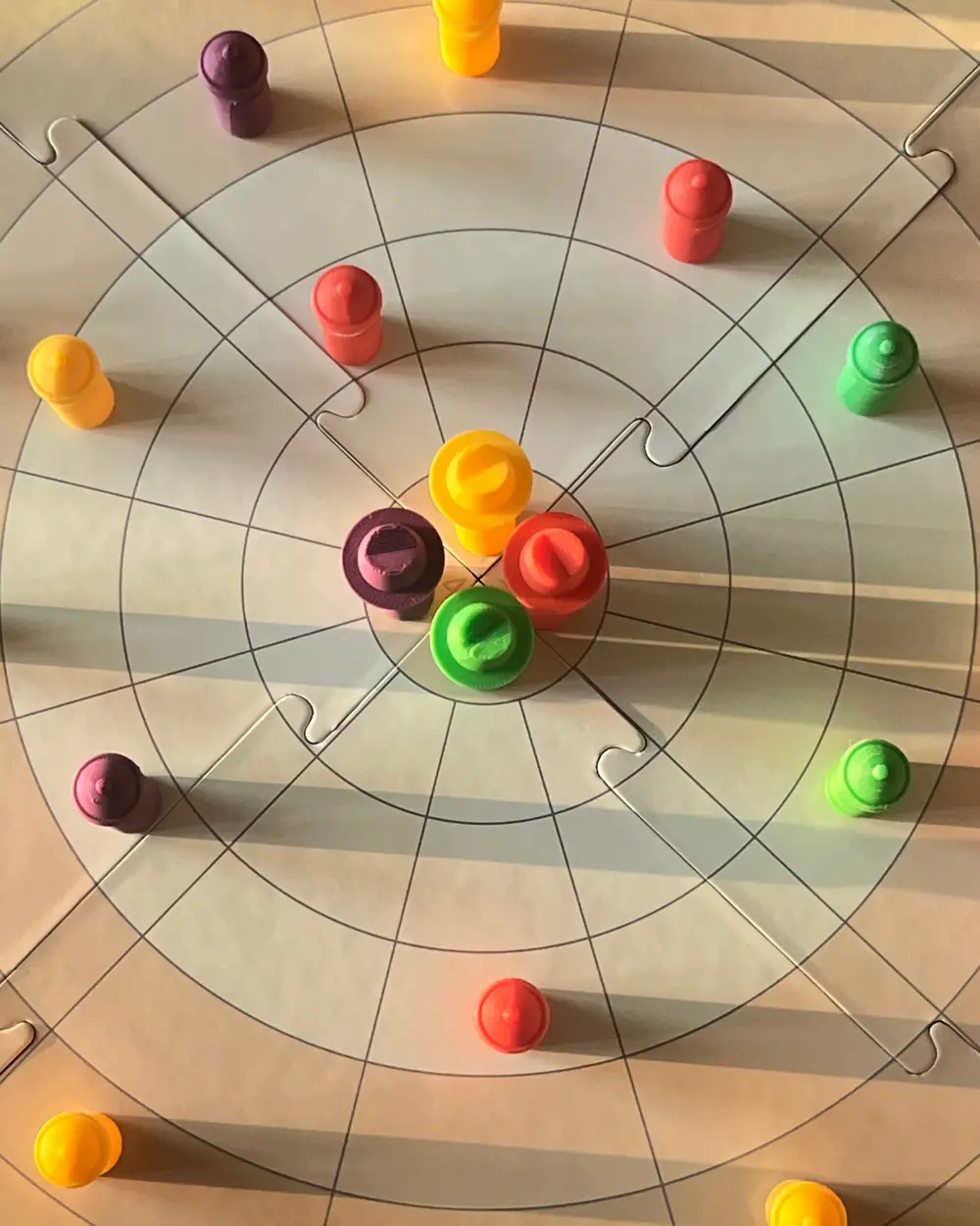 An Encircle game in afternoon light: four Dons in the safe house and coloured henchmen spread across the rings